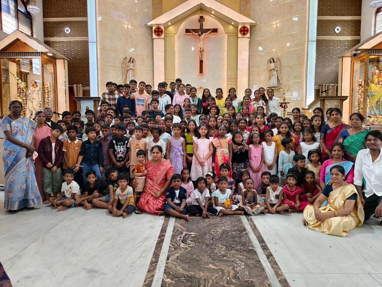 A large group of parish children and their teachers gathered in front of the sanctuary
